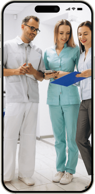Dental specialists reviewing patient records together on a mobile device