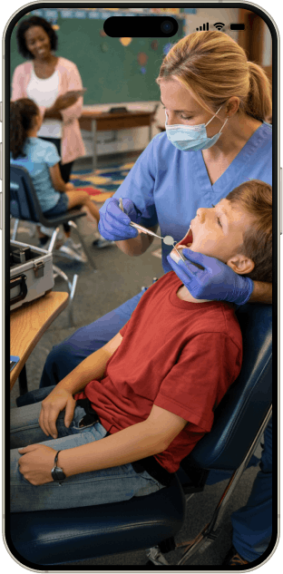 School dental program treating child inside mobile interface