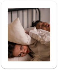 Sleeping couple experiencing snoring and airway issues