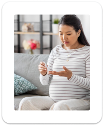 Pregnant woman holding medication bottle