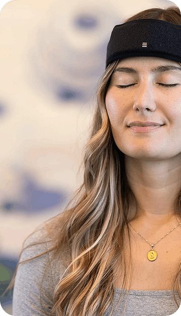 Woman wearing SONU sleep therapy device